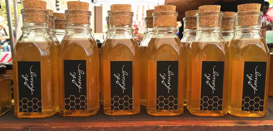 glass bottles of honey with cork stoppers from Oh Honey Apiaries